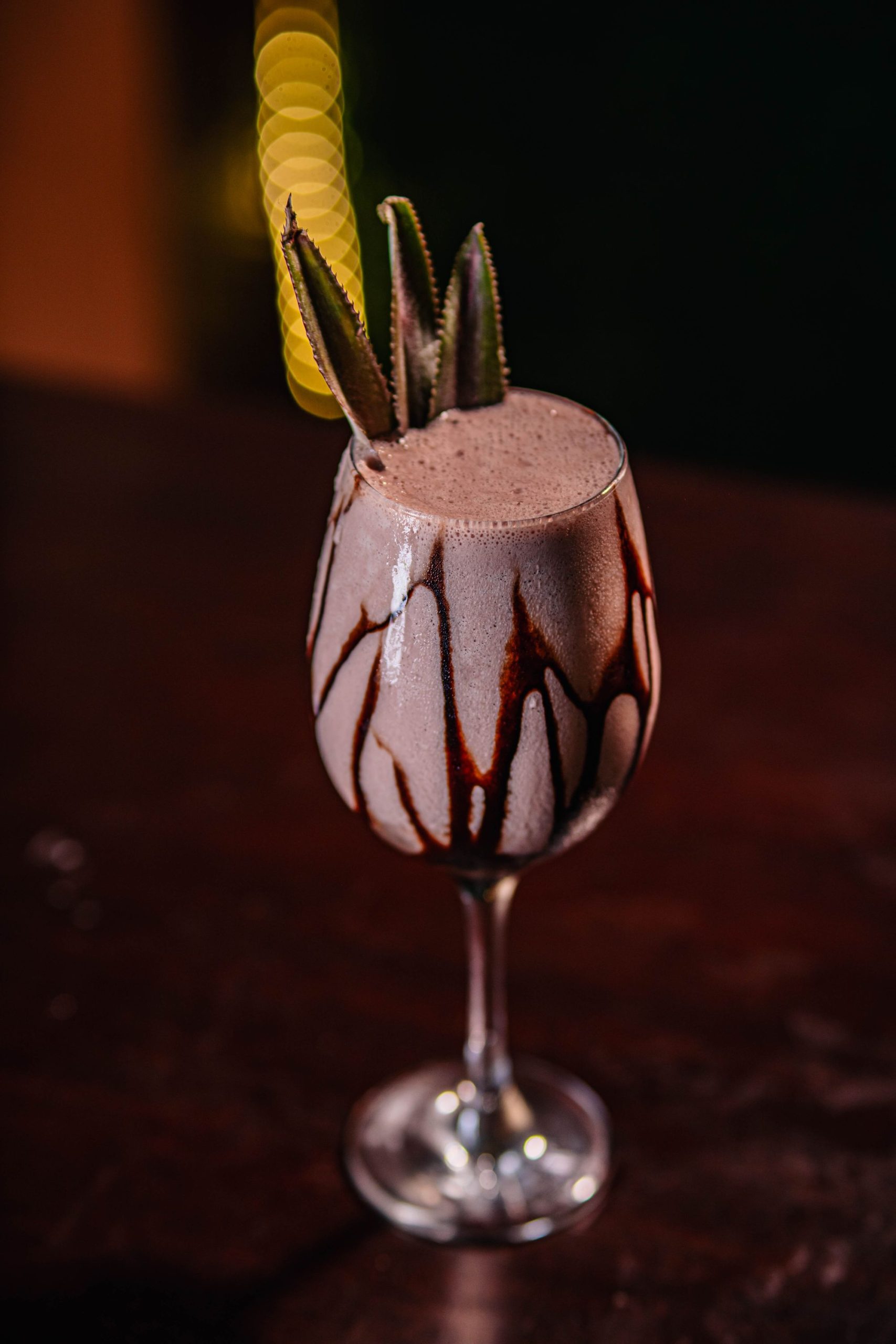Moody close-up of a chocolate dessert cocktail with chocolate garnish