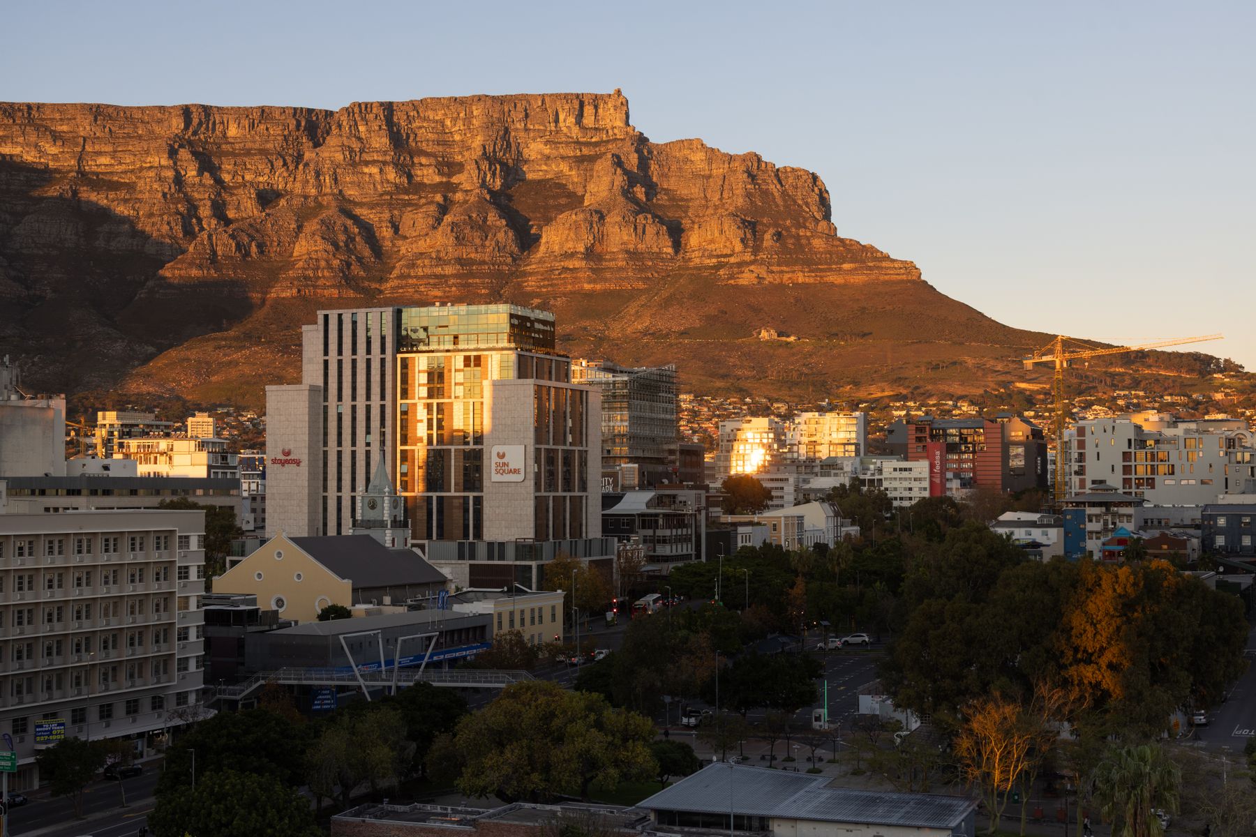 Table Mountain glowing orange above the Cape Town city center at sunset
