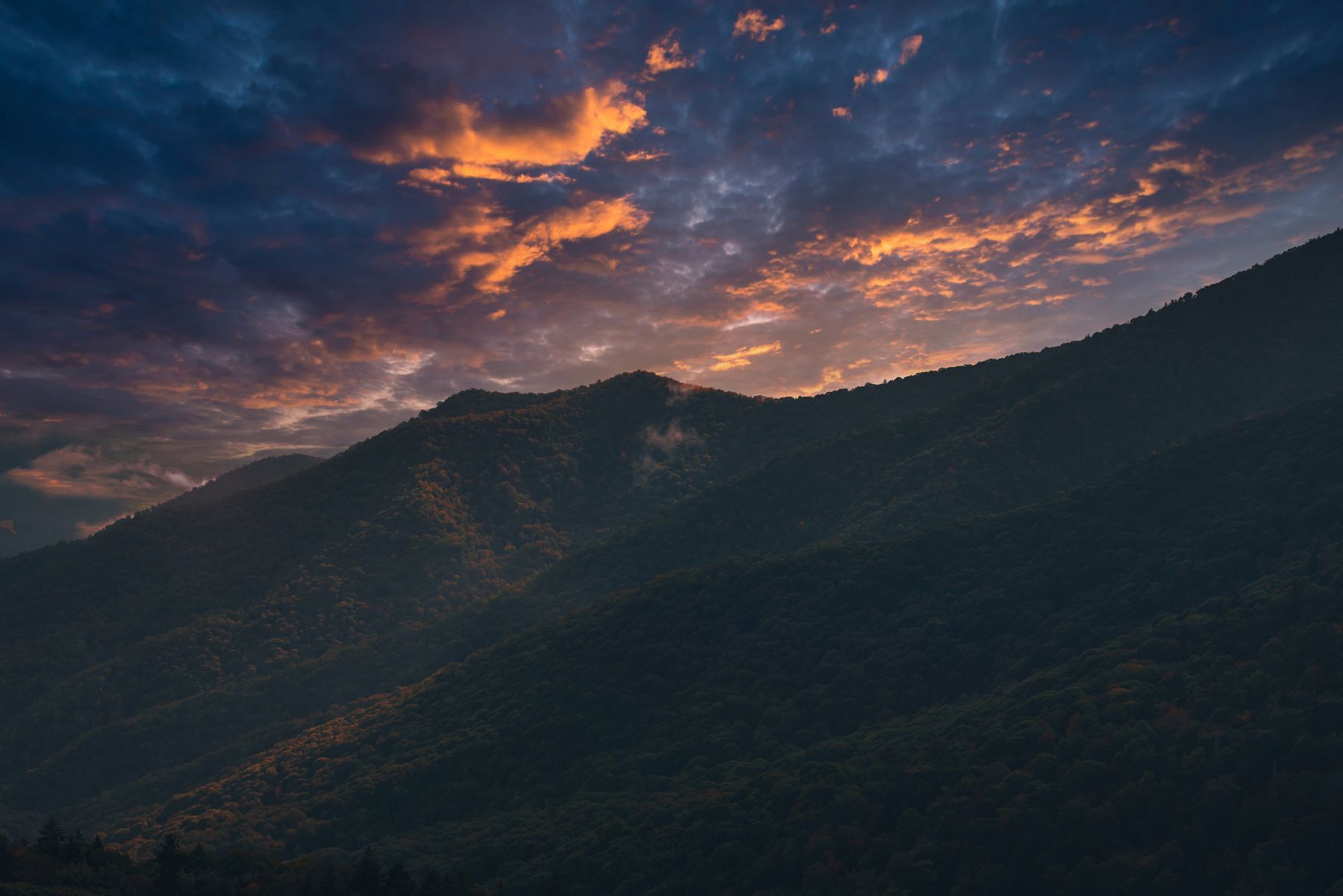 Fiery sunset clouds over a silhouetted ridge in the Great Smoky Mountains