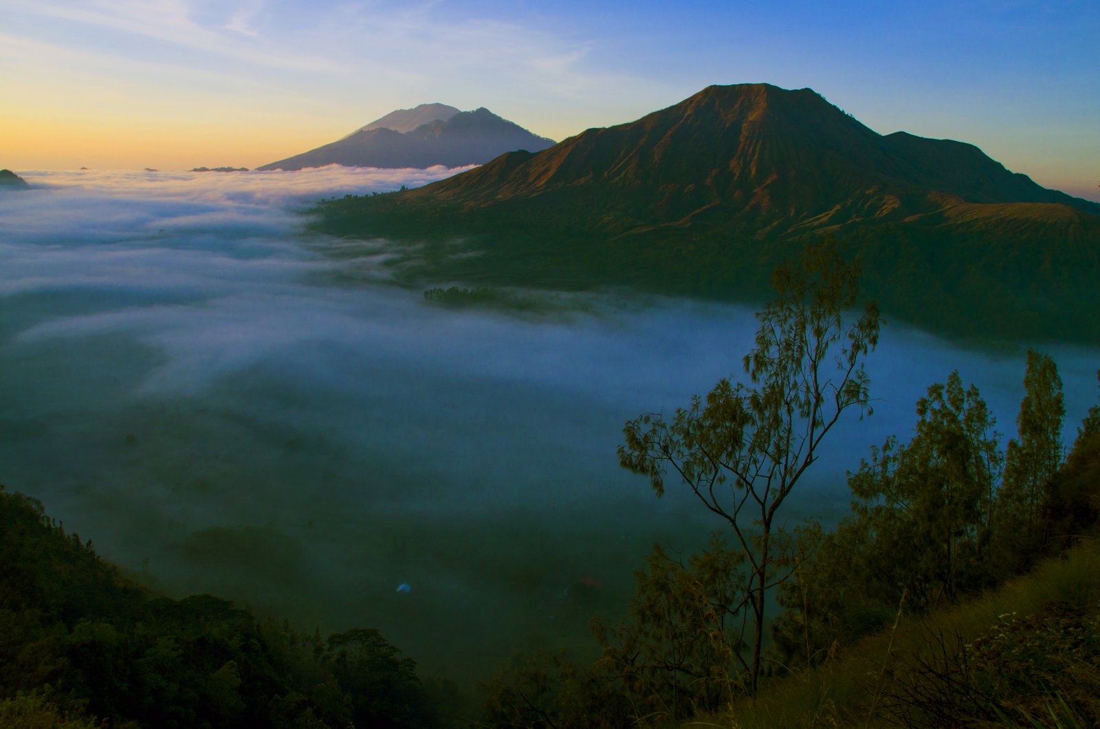 Mount Batur in morning fog seen from Pinggan village