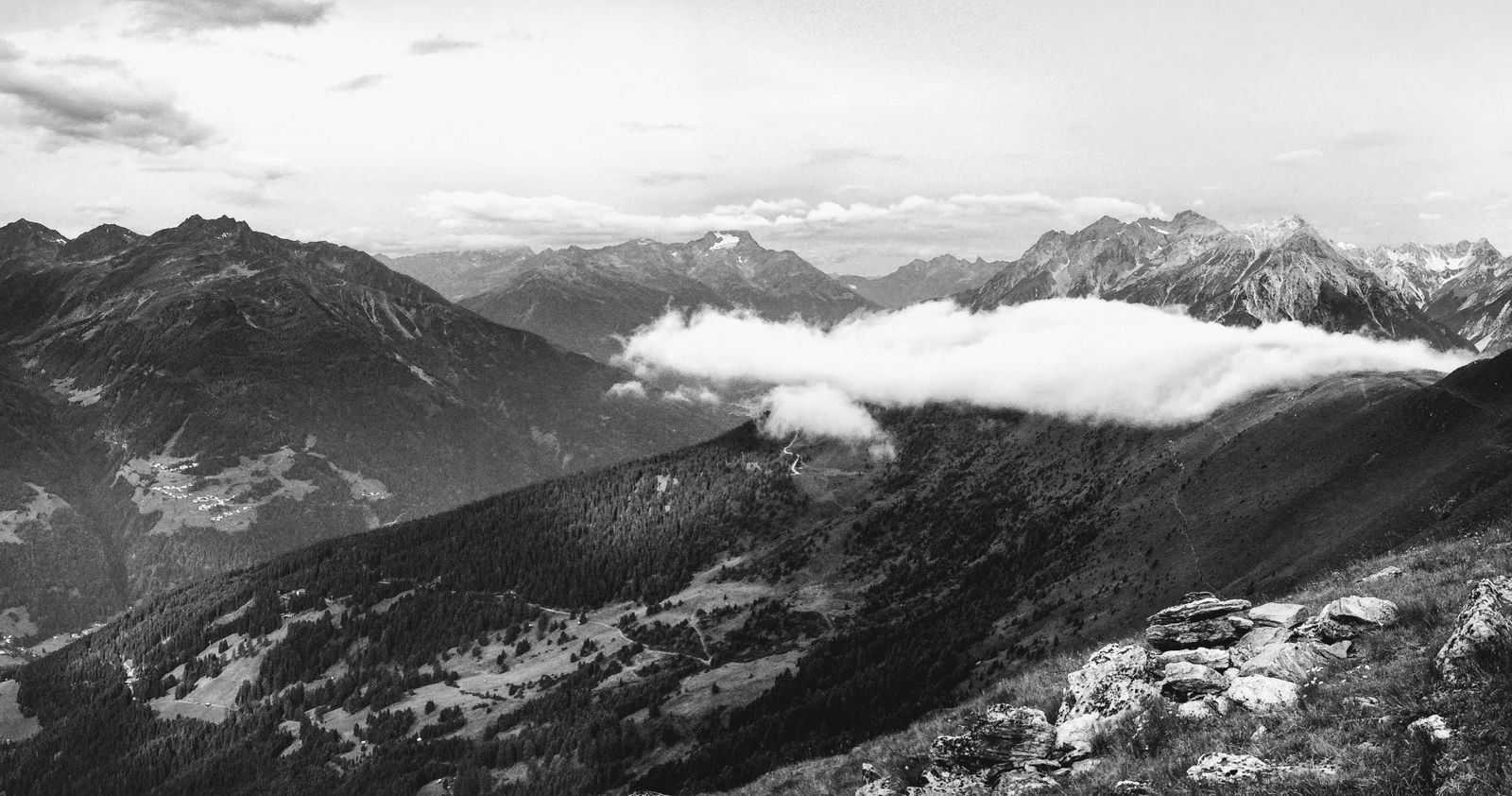 Black and white mountain ridges under a moody sky