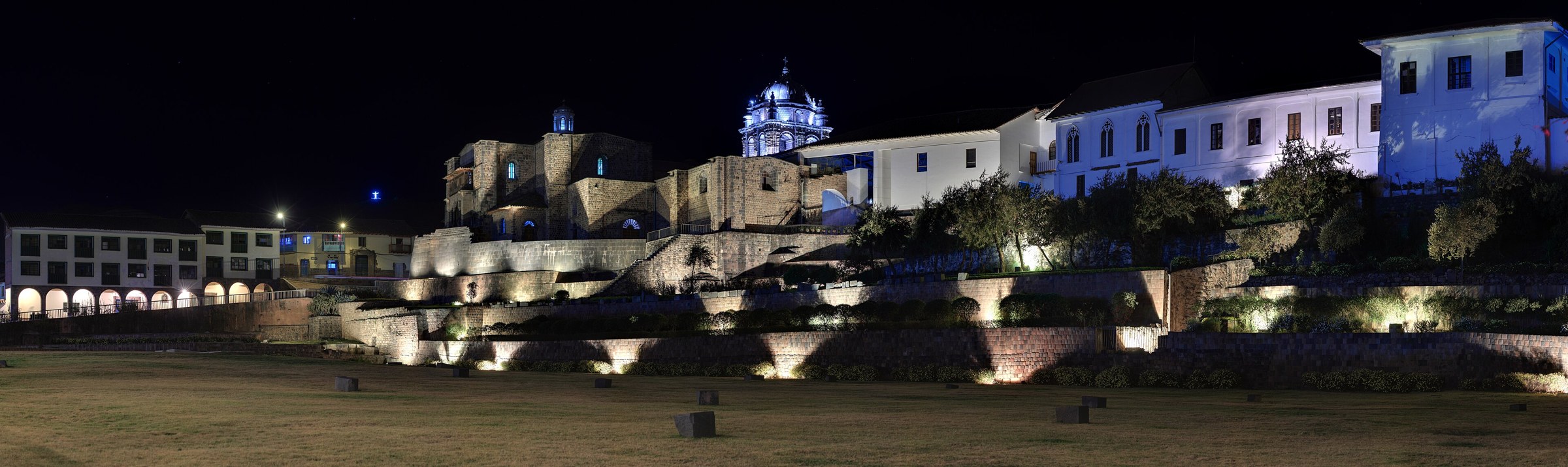 Qorikancha stonework and Santo Domingo architecture illuminated at night.