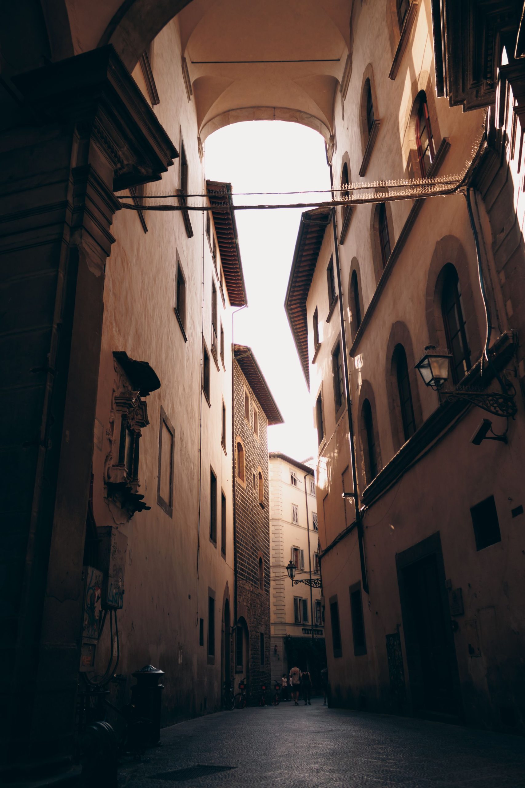 Light and shadow between buildings on a narrow Florence street