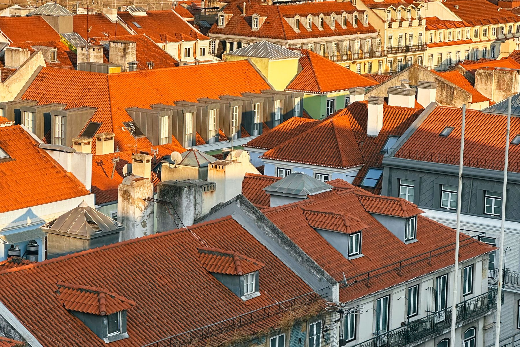 Orange tiled rooftops of Lisbon in warm golden light