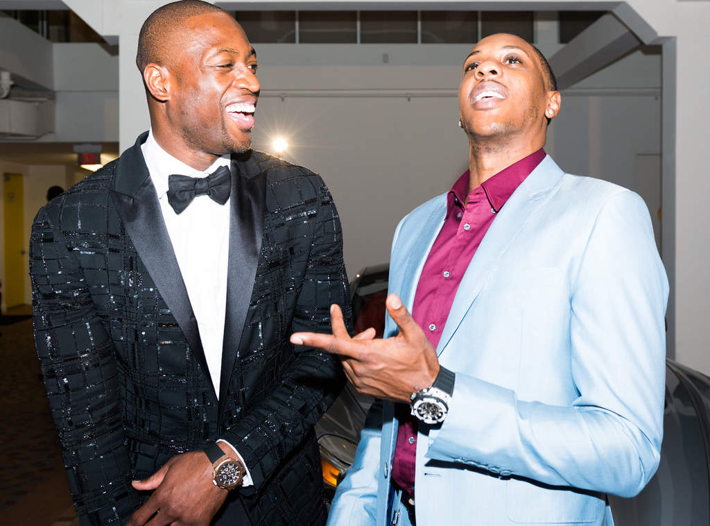 Two guests talking at an indoor event while photographed with flash