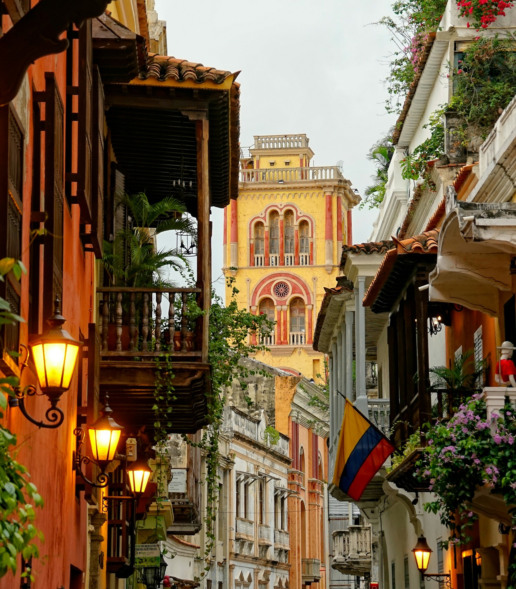 Colonial balconies and warm lamps along a Cartagena street