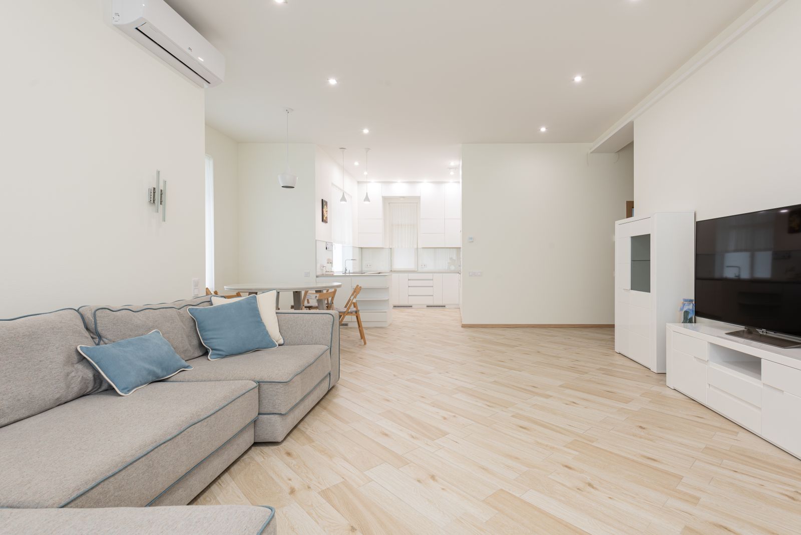 Clean living room with soft sofa and neutral tones edited for real estate