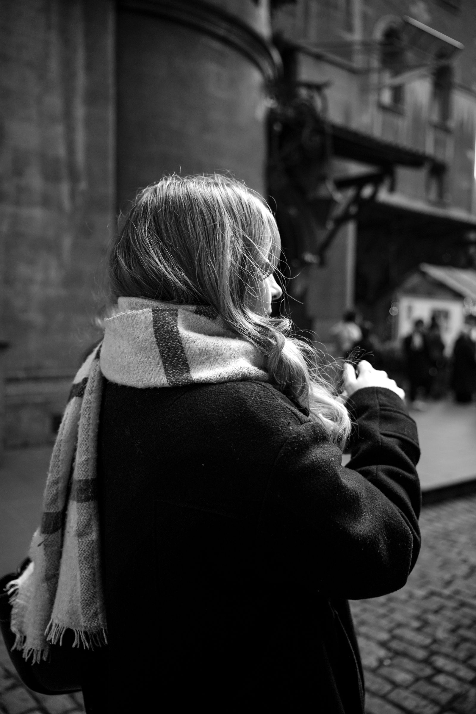 Black and white portrait of a person on a city street
