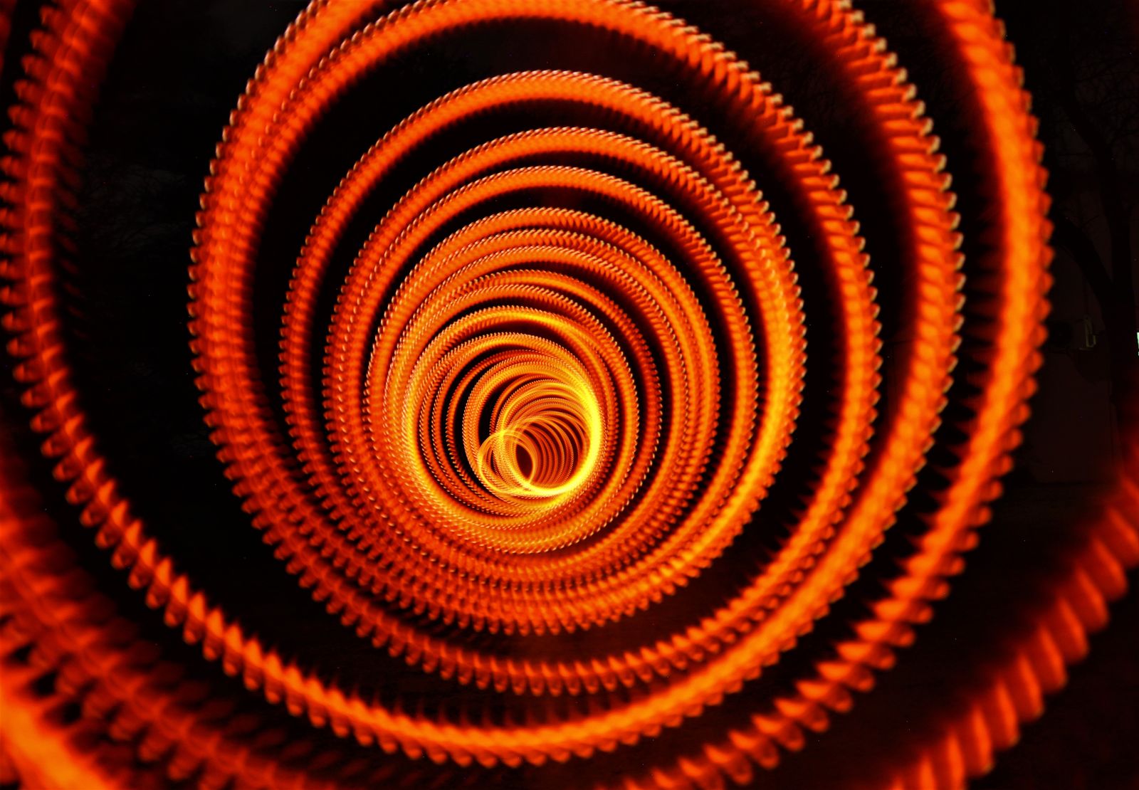 Orange and black spiral light painting made with a long exposure