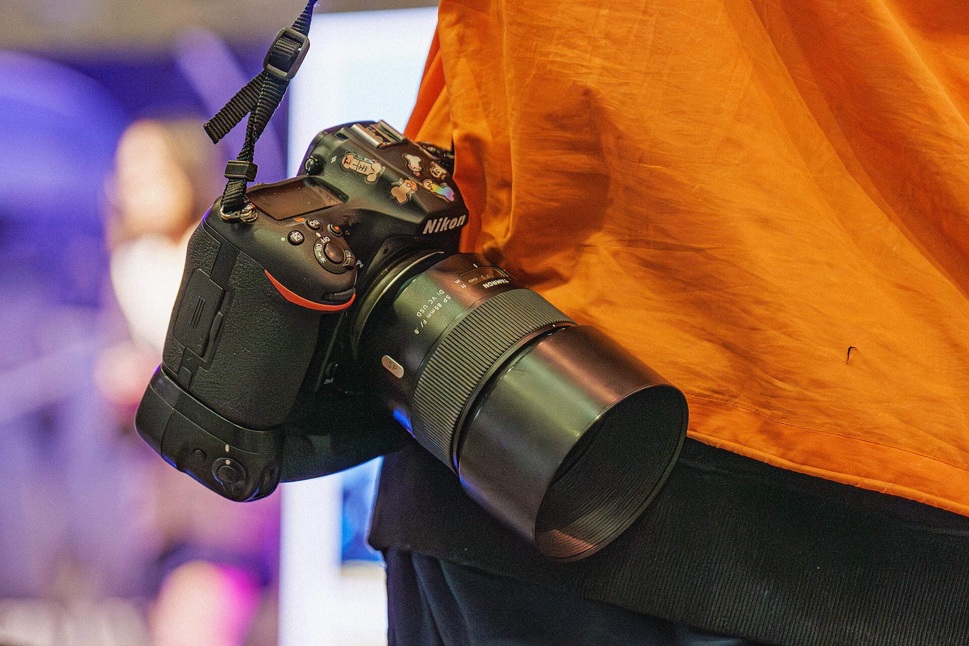 Nikon D850 - Nikon D850 with an 85mm lens carried on a strap