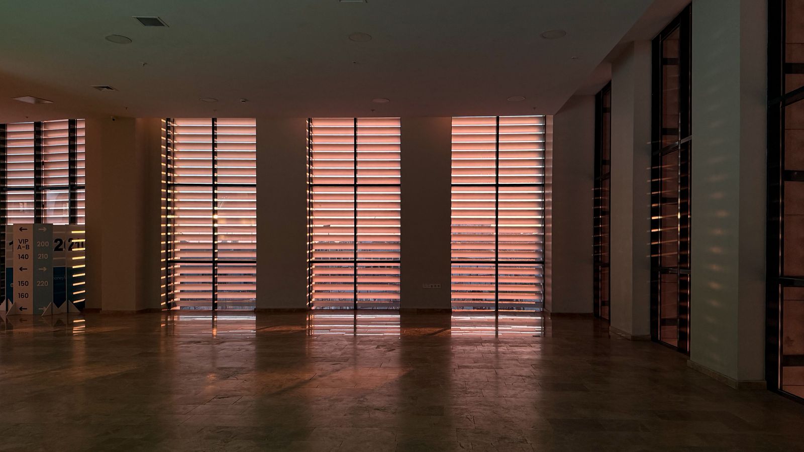 Empty room with strong window light and deep interior shadows needing HDR