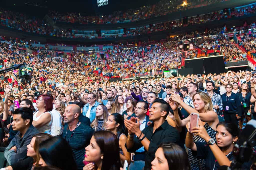 Concert audience filling an arena during a live performance