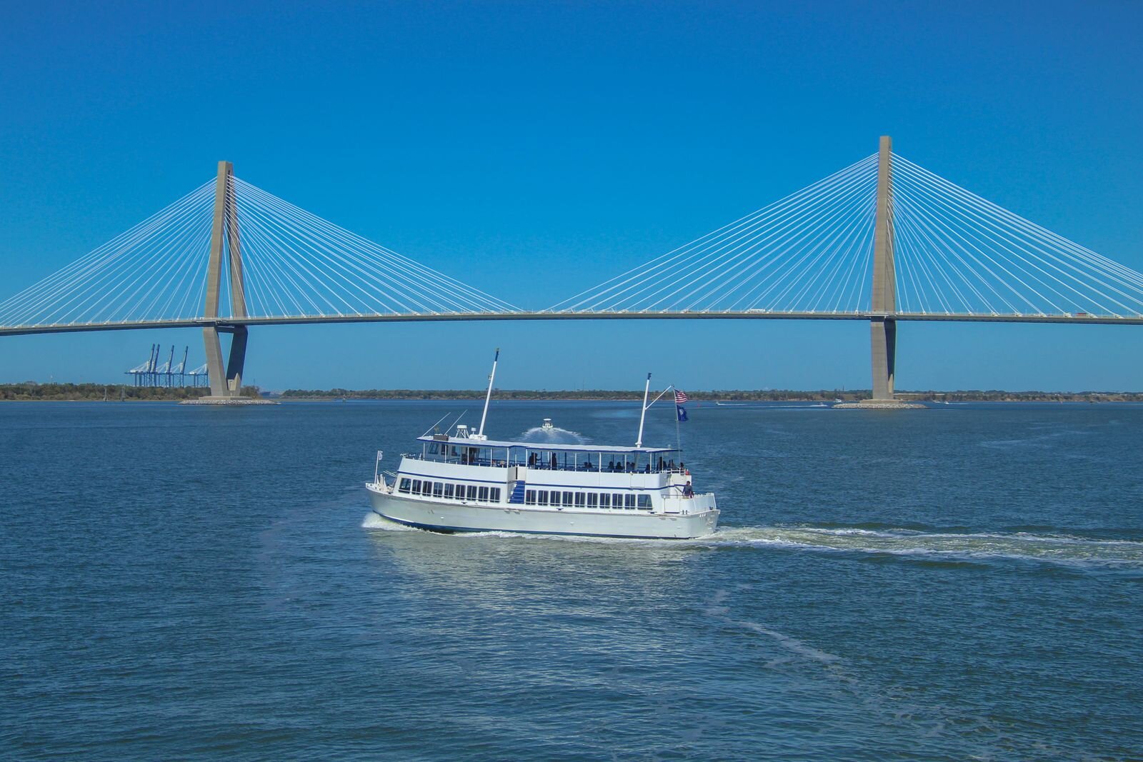 Tour boat on Charleston Harbor in front of the Arthur Ravenel Jr. Bridge, Charleston, South Carolina