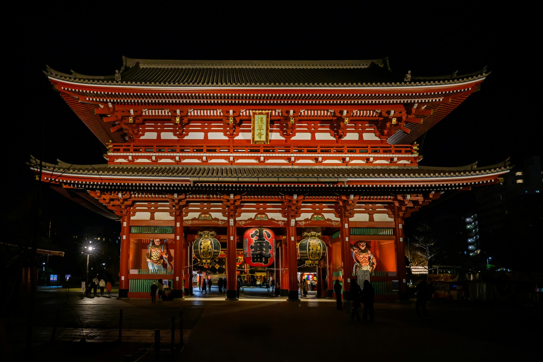 Red Hozomon gate at Senso-ji illuminated against the night sky in Asakusa, Tokyo