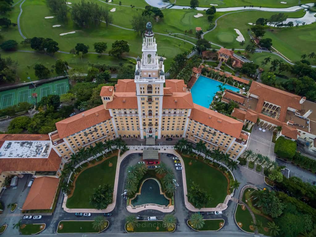 Aerial view of the Biltmore Hotel tower, red roofs and pool in Coral Gables
