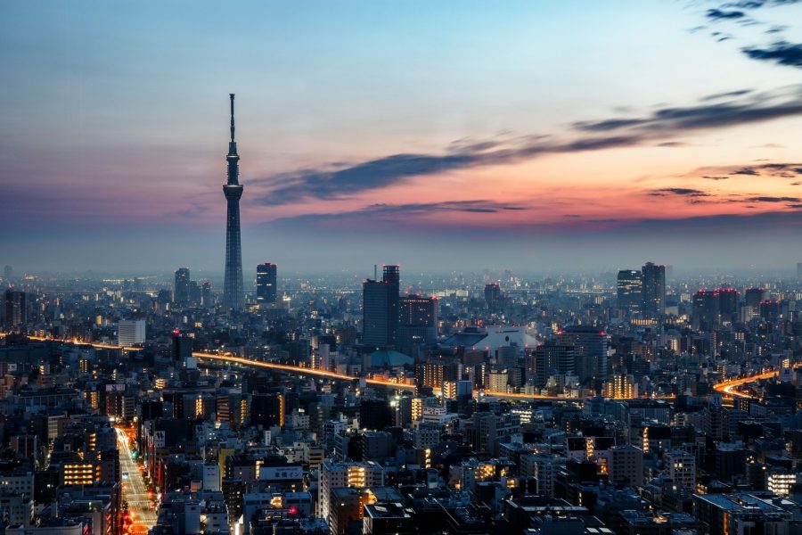 Tokyo Skytree above a dense city skyline under a pink and blue dusk sky
