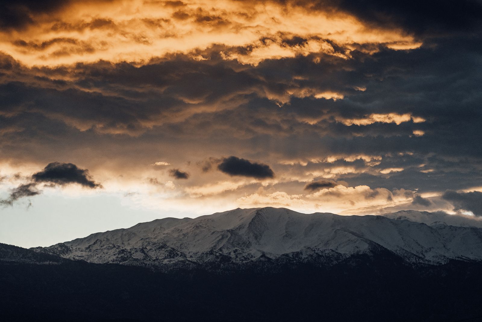 Dramatic clouds over mountains at sunset