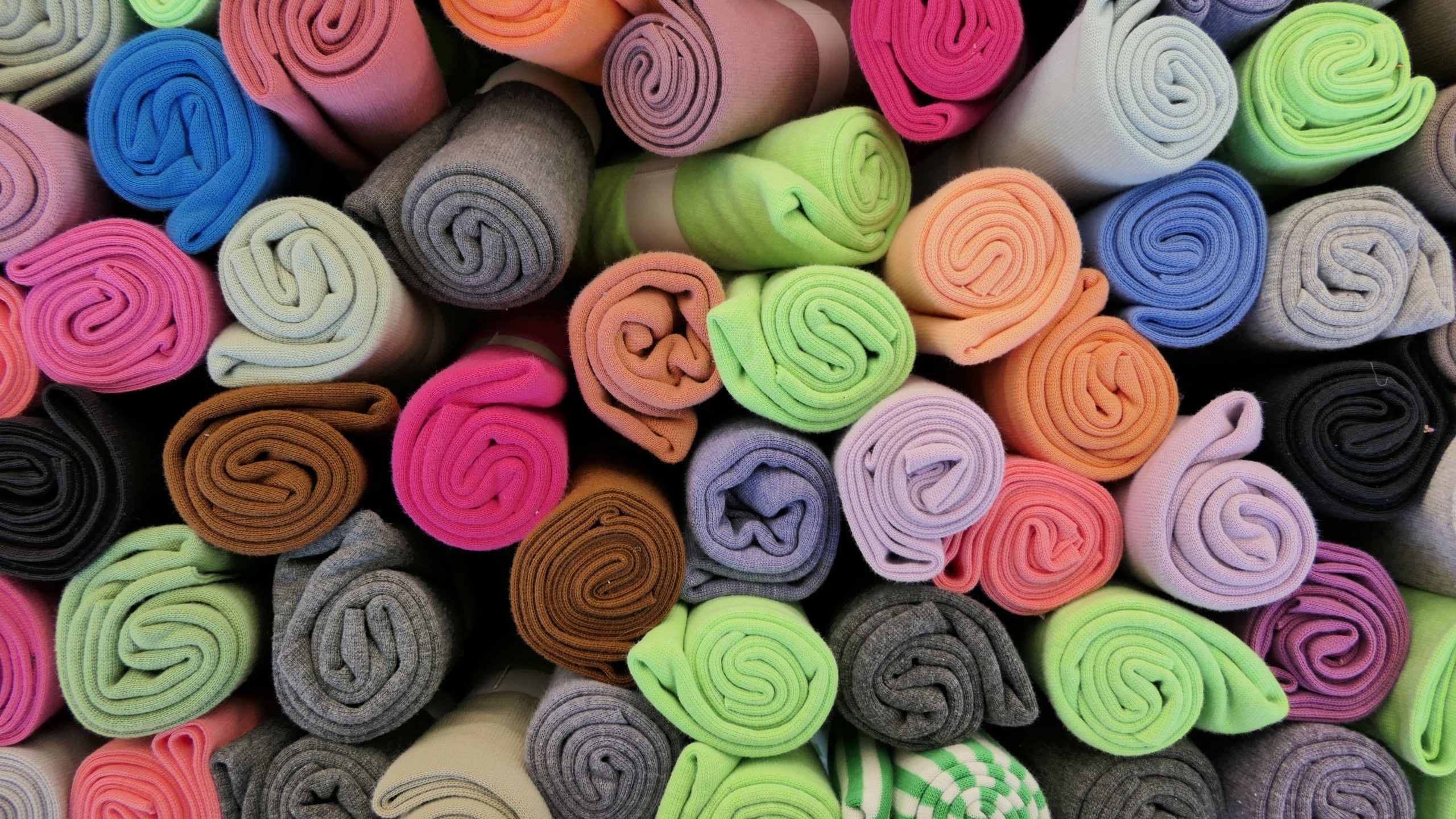 Colorful rolled fabric backdrop material in many colors