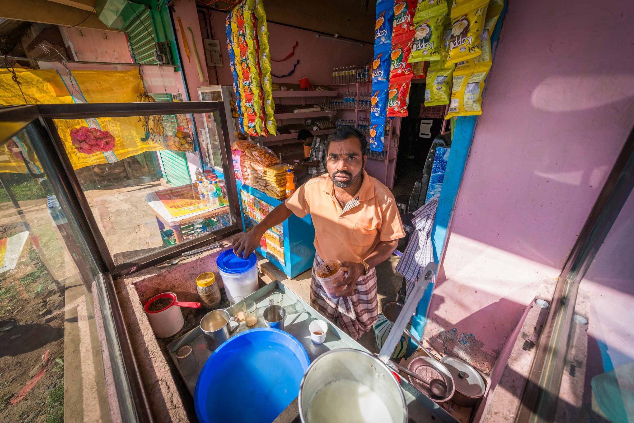 A roadside shop in India photographed in soft flat light, the kind of frame to correct before grading
