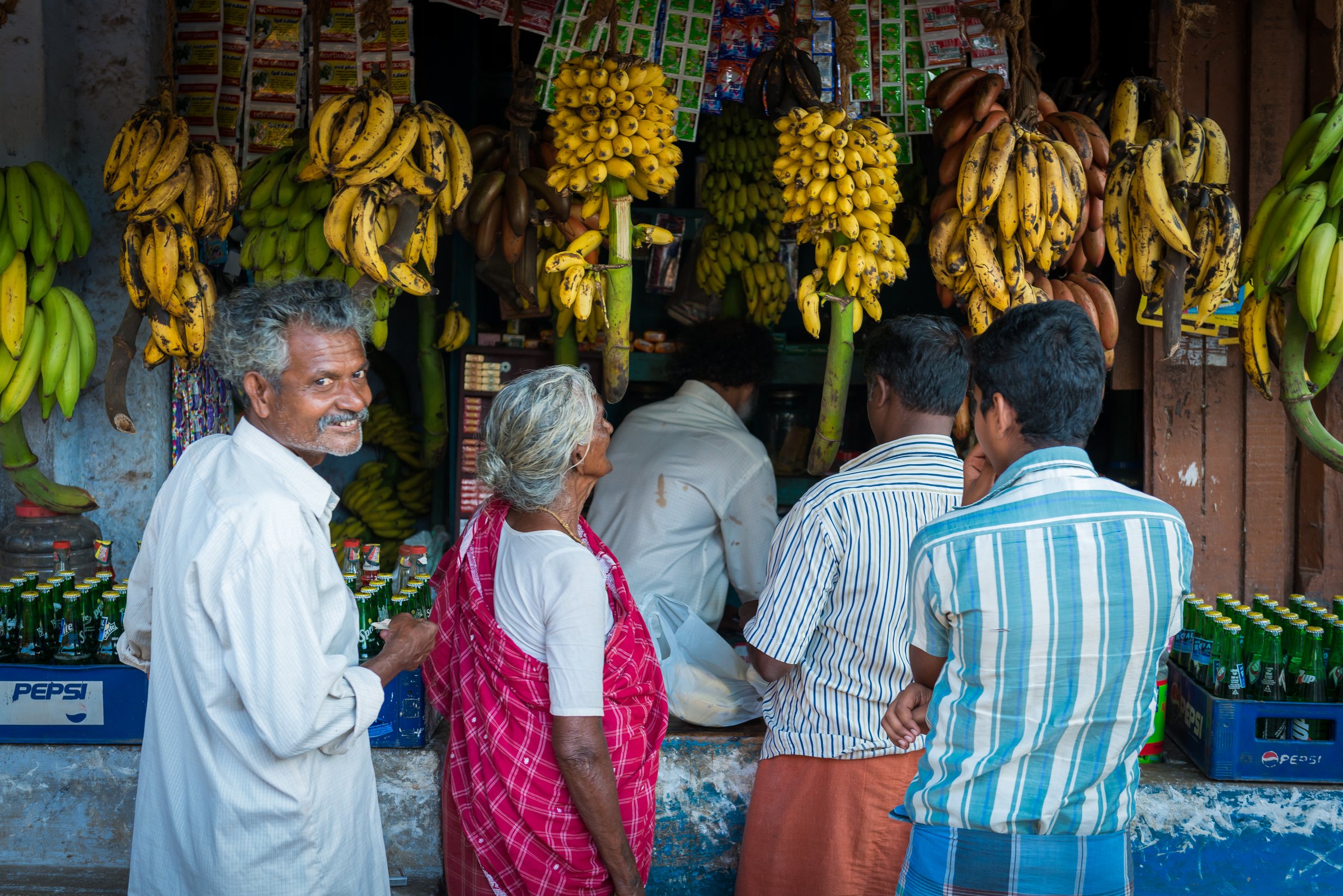 A banana market in India in dim light, deep shadow and warm highlights setting a moody tone
