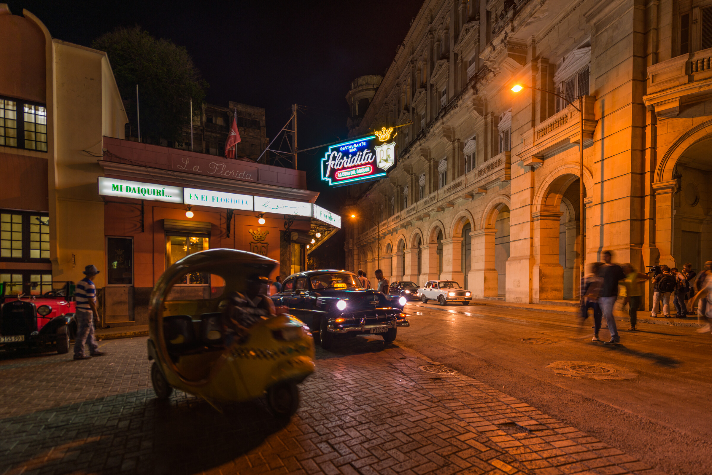 The Floridita bar sign glowing on a Havana street at night