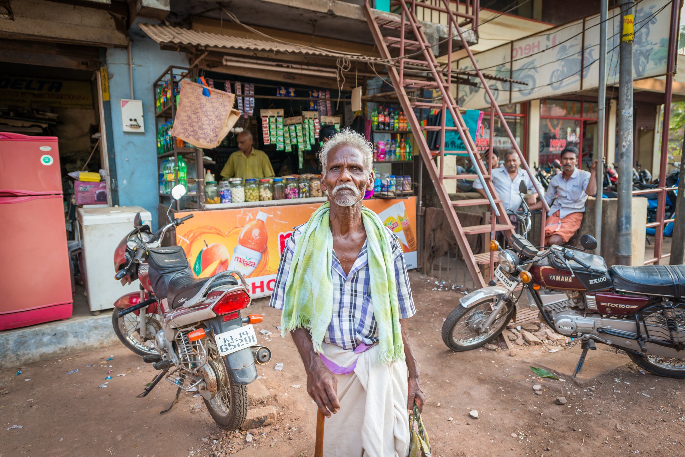 A street market in India with mixed shade and sunlight, a test case for global corrections