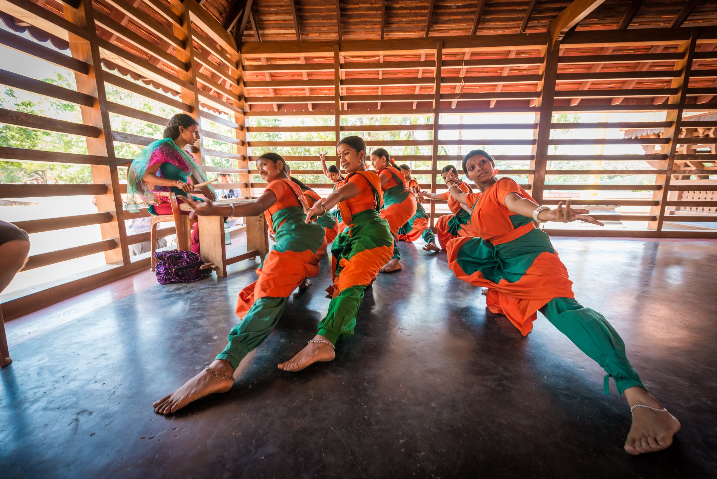 Kalaripayattu dancers training in slatted window light in Kerala, India
