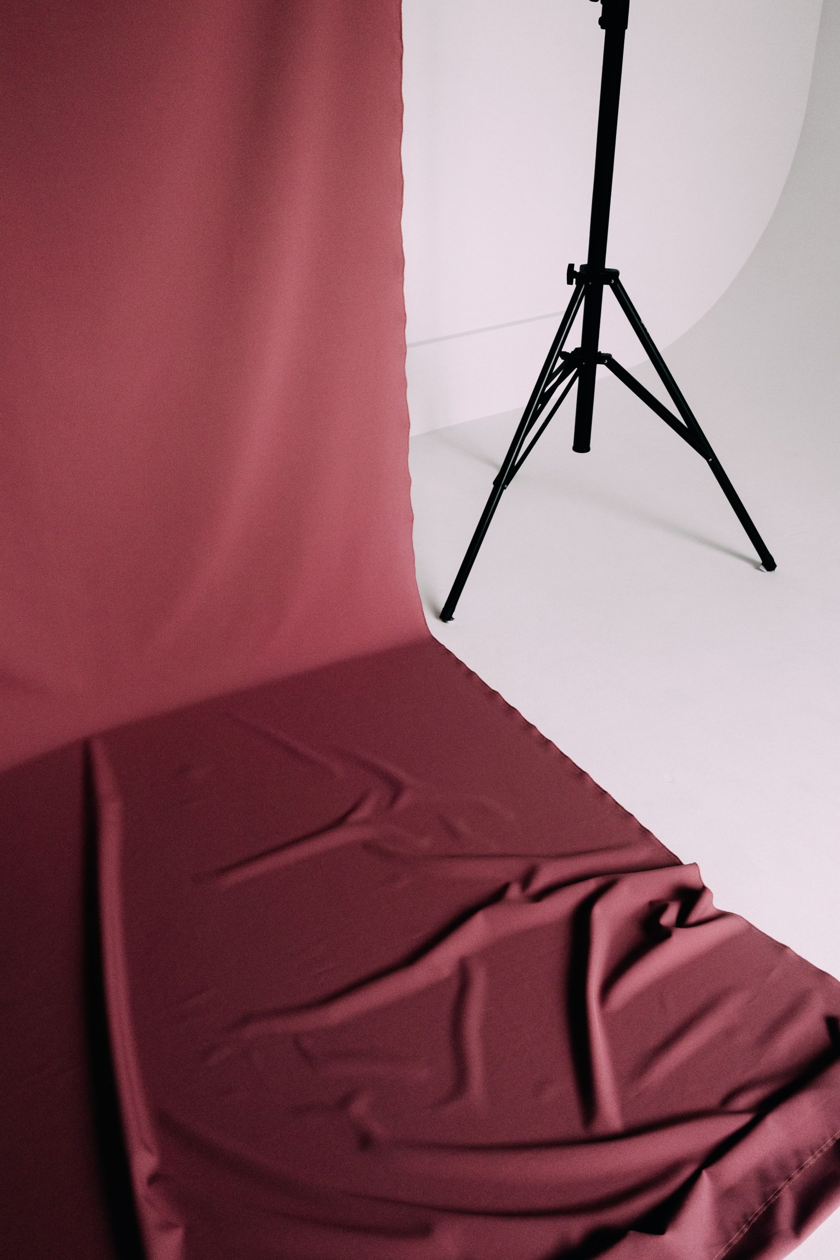 Burgundy fabric backdrop material draped and lit for a portrait session