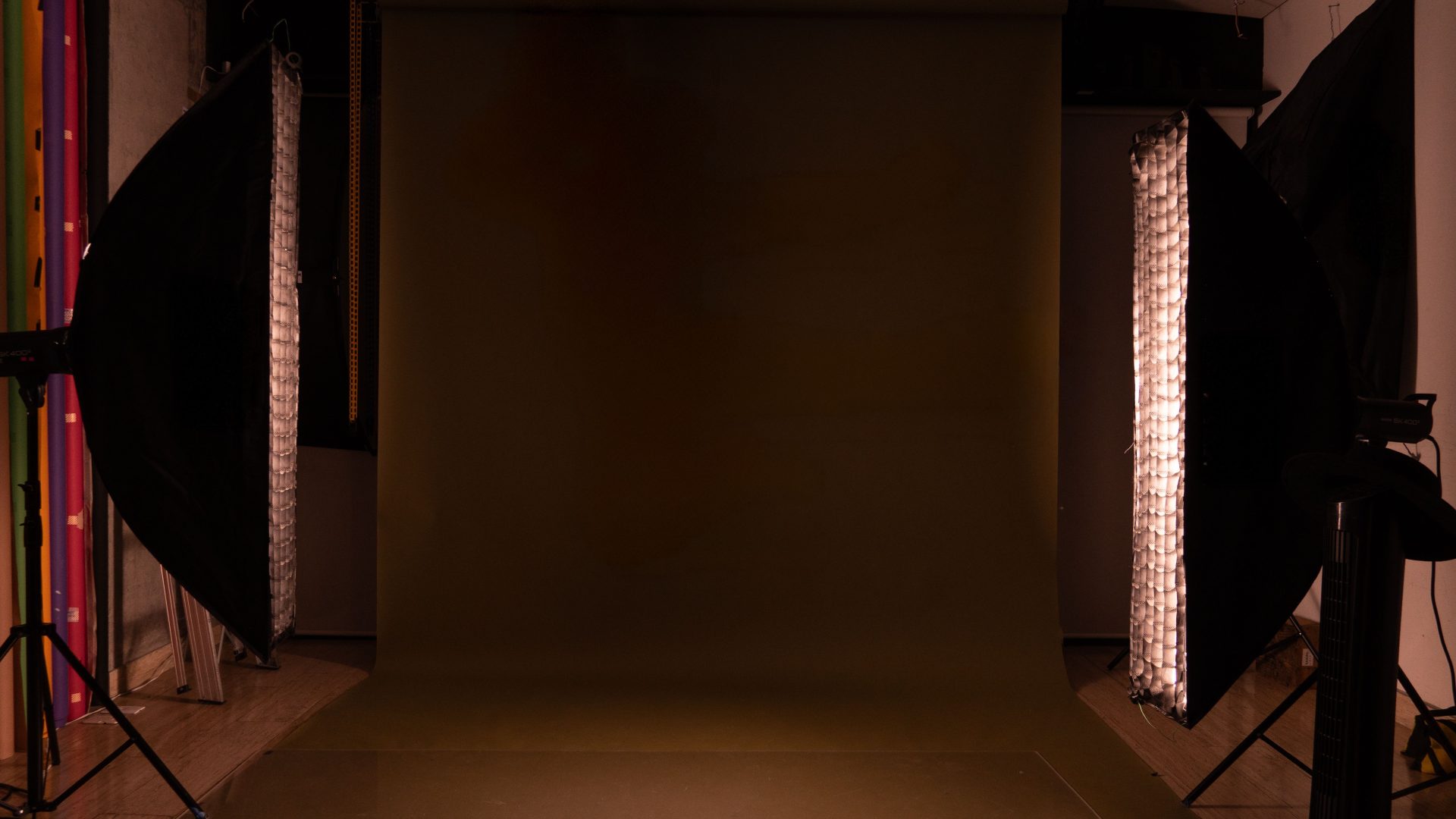 A mocha-toned studio backdrop with soft light, set for portrait photography