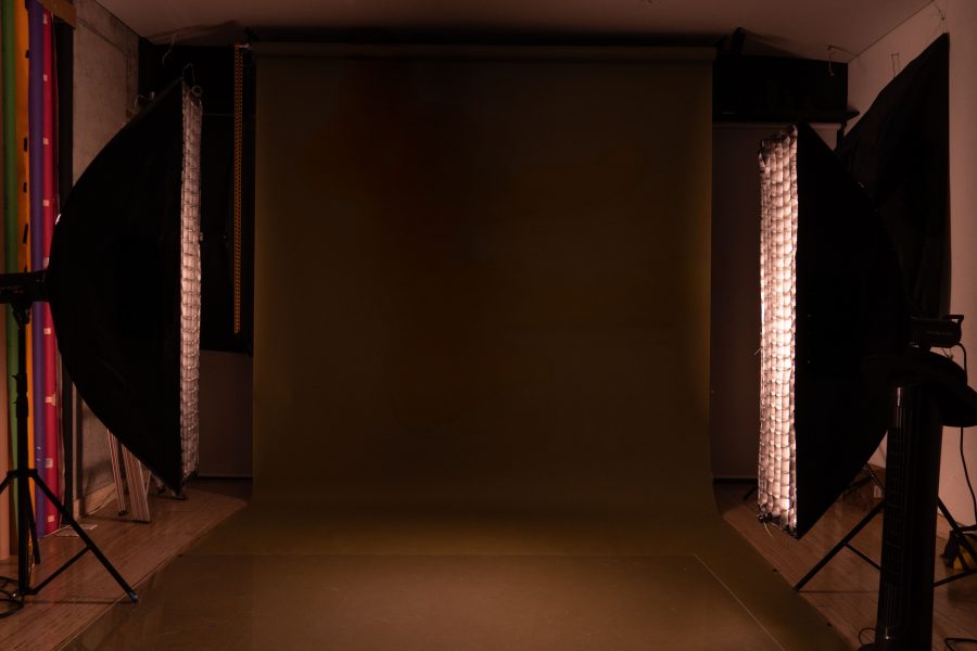 A mocha-toned studio backdrop with soft light, set for portrait photography