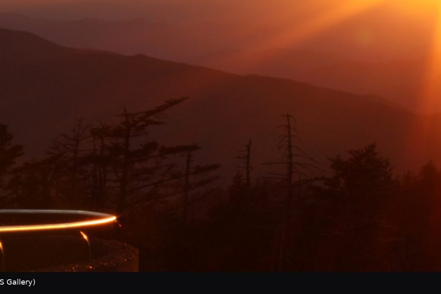 Sunset sunburst over layered blue ridges in Great Smoky Mountains National Park.