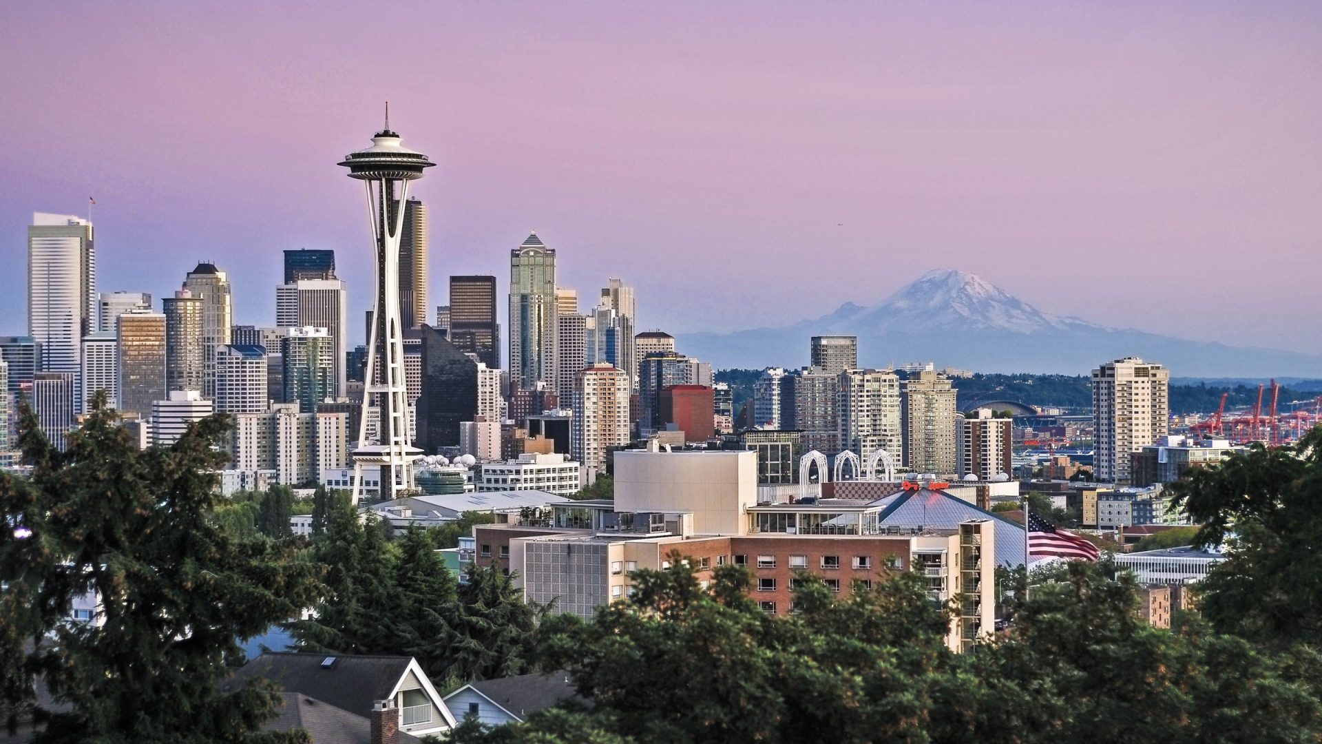 Seattle skyline with Space Needle and Mount Rainier beneath a pink sky