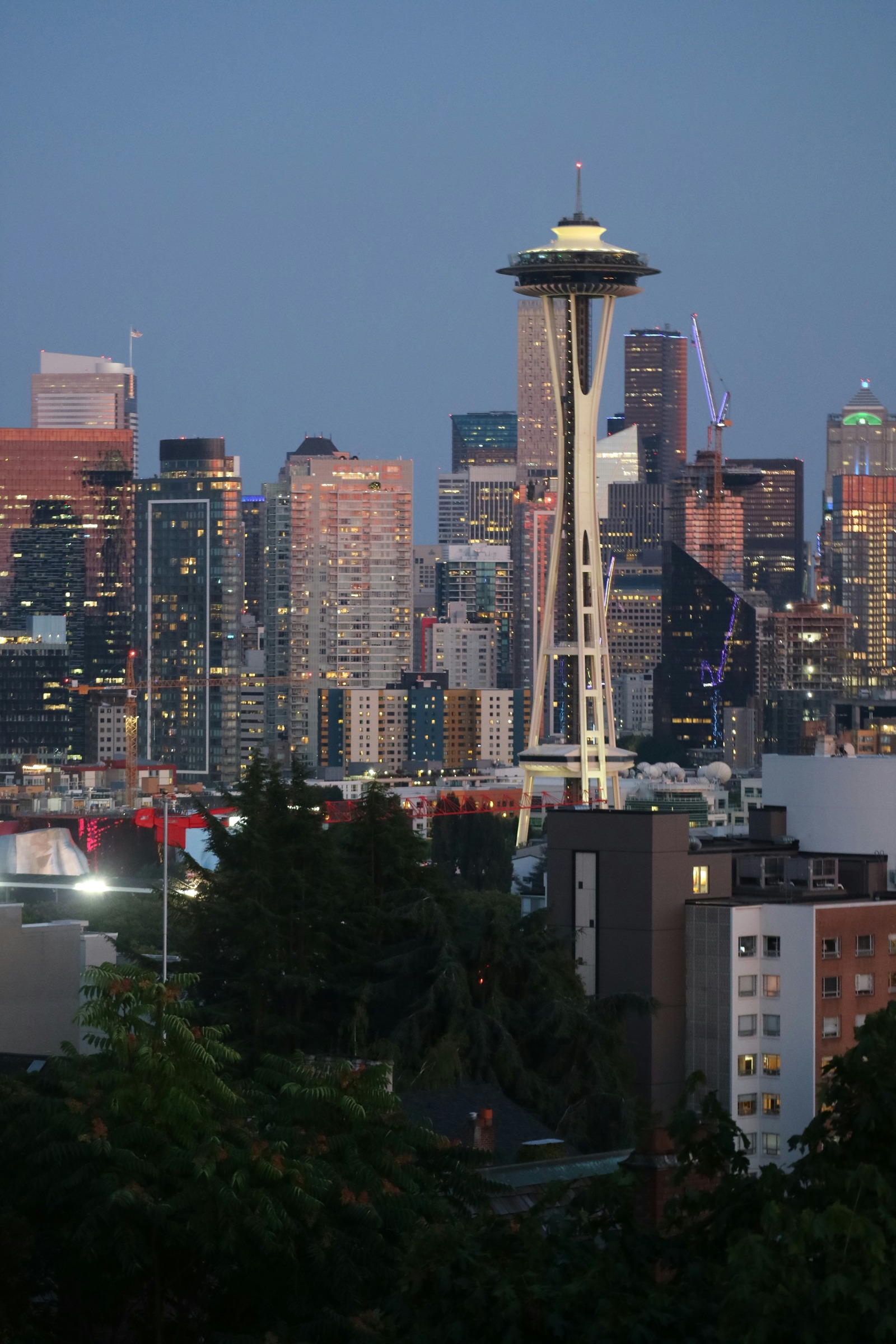 Space Needle and illuminated Seattle buildings in a vertical evening frame