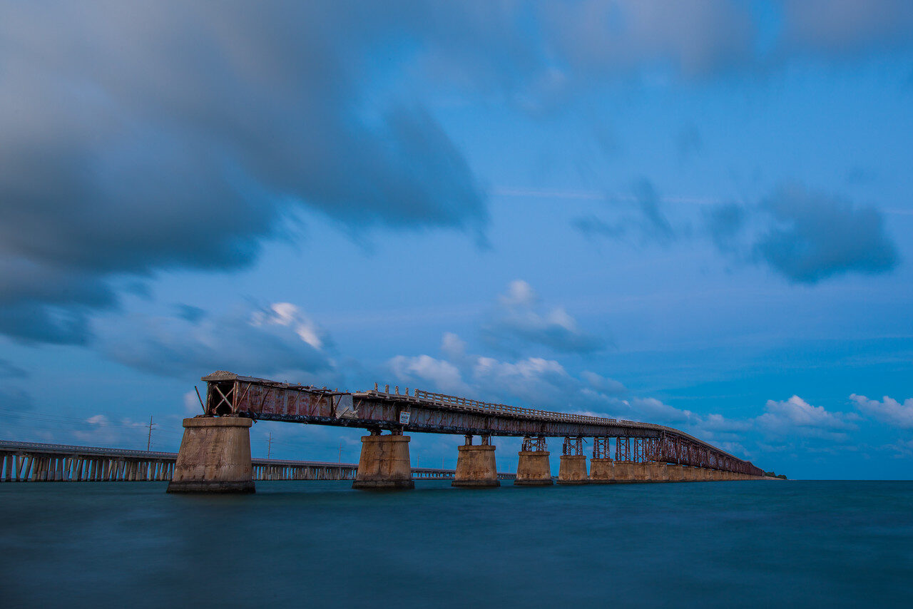 Wide Bahia Honda old bridge profile under blue clouds, historic photograph by Edin Chavez
