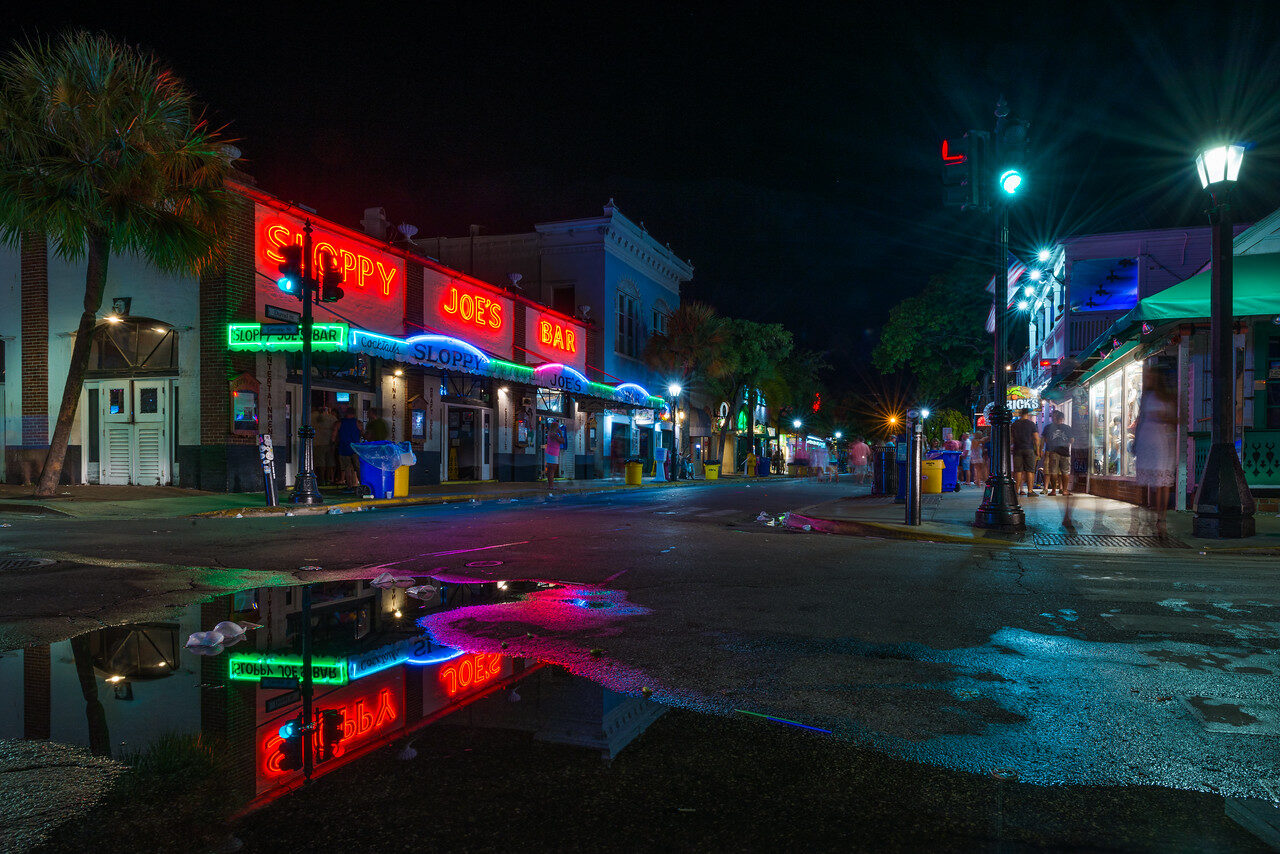 Sloppy Joe's night signs reflected in rainwater, historic photograph by Edin Chavez