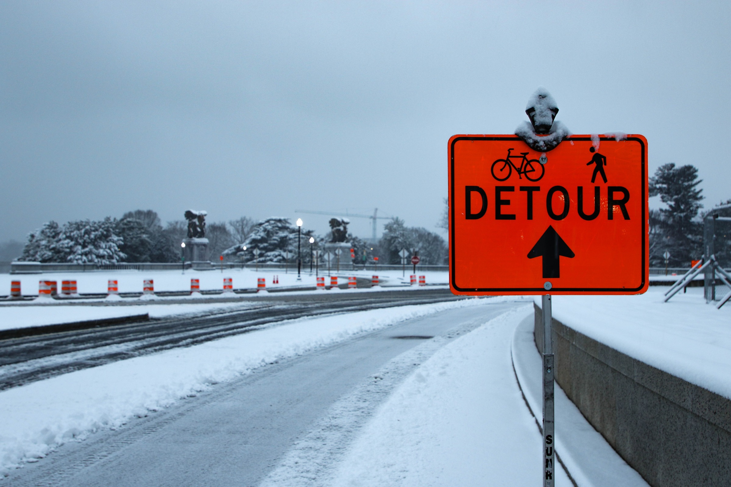 Snow-covered bicycle and pedestrian detour sign near Lincoln Memorial