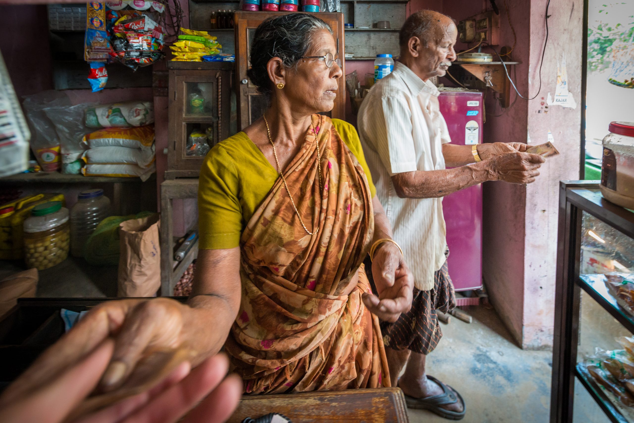 Woman and man inside a shop beside a bright opening
