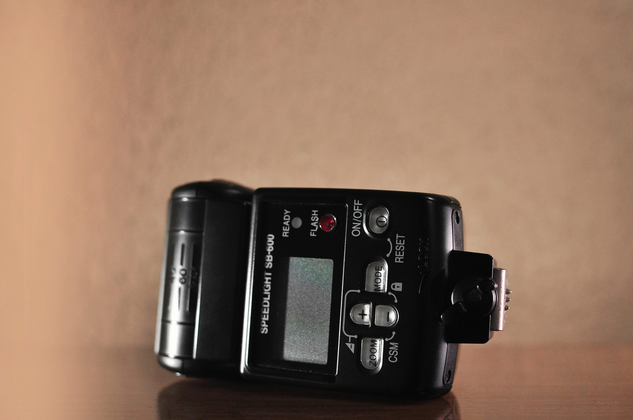 Close-up of an SB-600 speedlight control panel with ready light and buttons