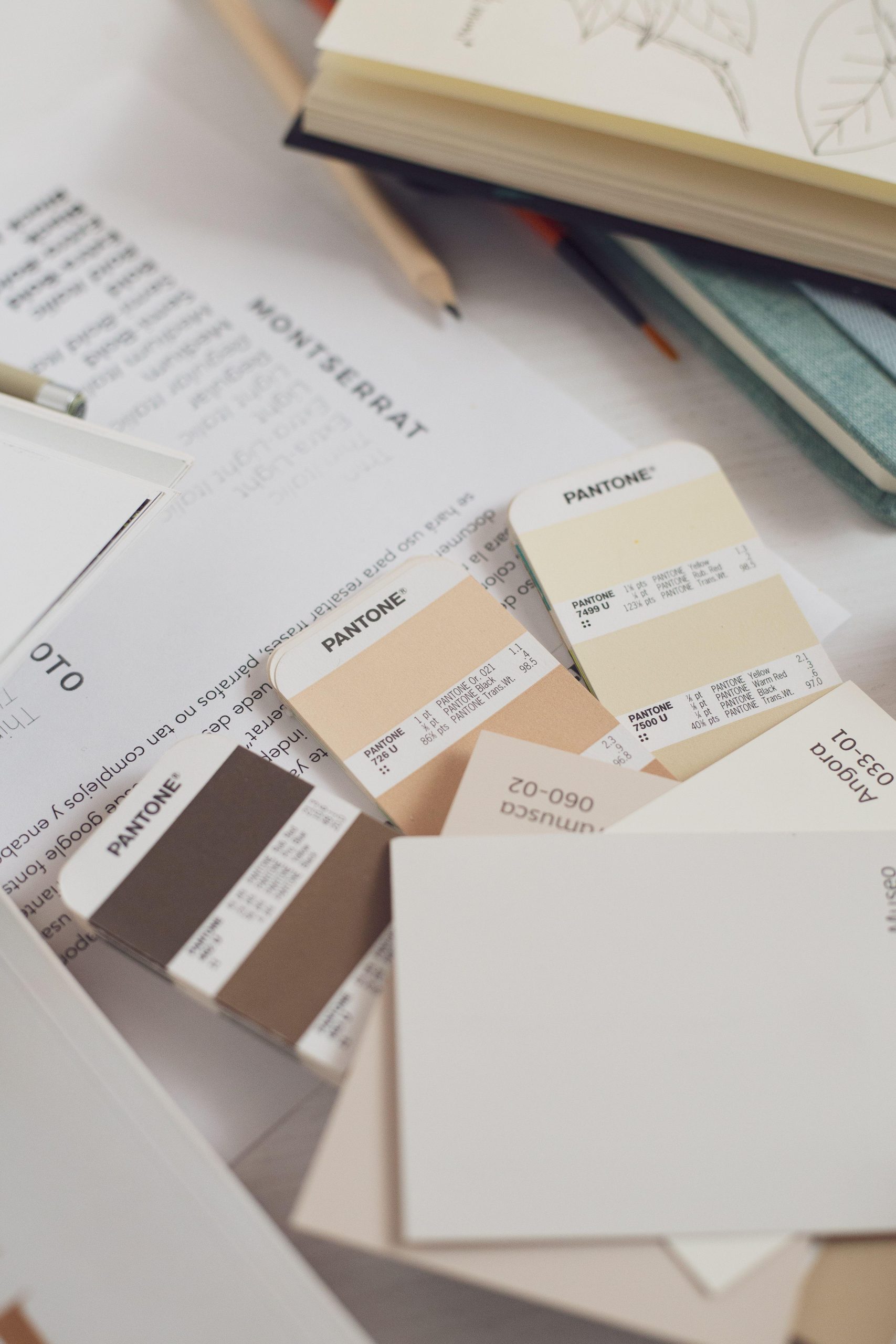 Neutral Pantone color swatches on a design desk. (Stock photo, illustrative.)