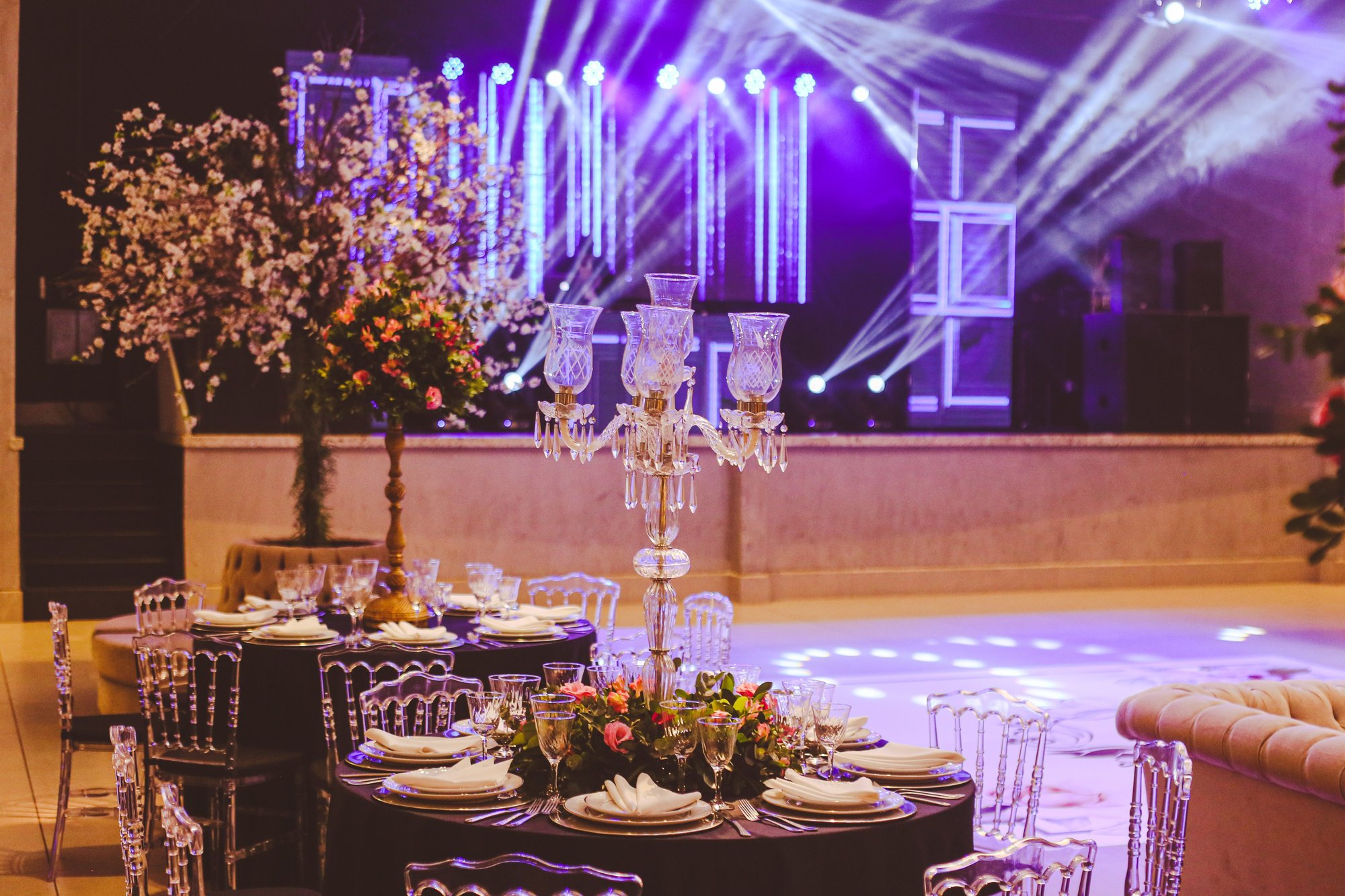 An empty banquet hall set with candelabra centerpieces under event lighting. (Stock photo, illustrative.)
