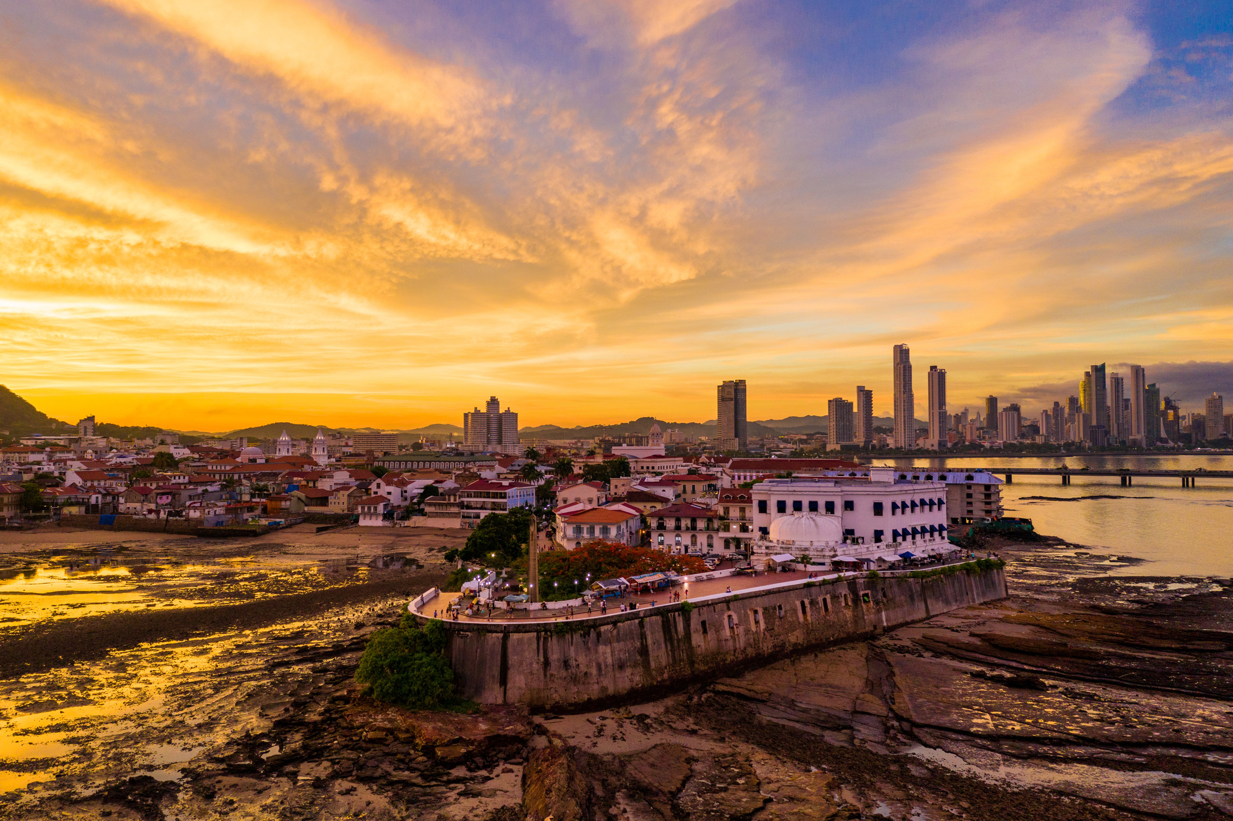 Casco Antiguo roof lines and the modern Panama City skyline in warm evening light, photographed by Edin Chavez