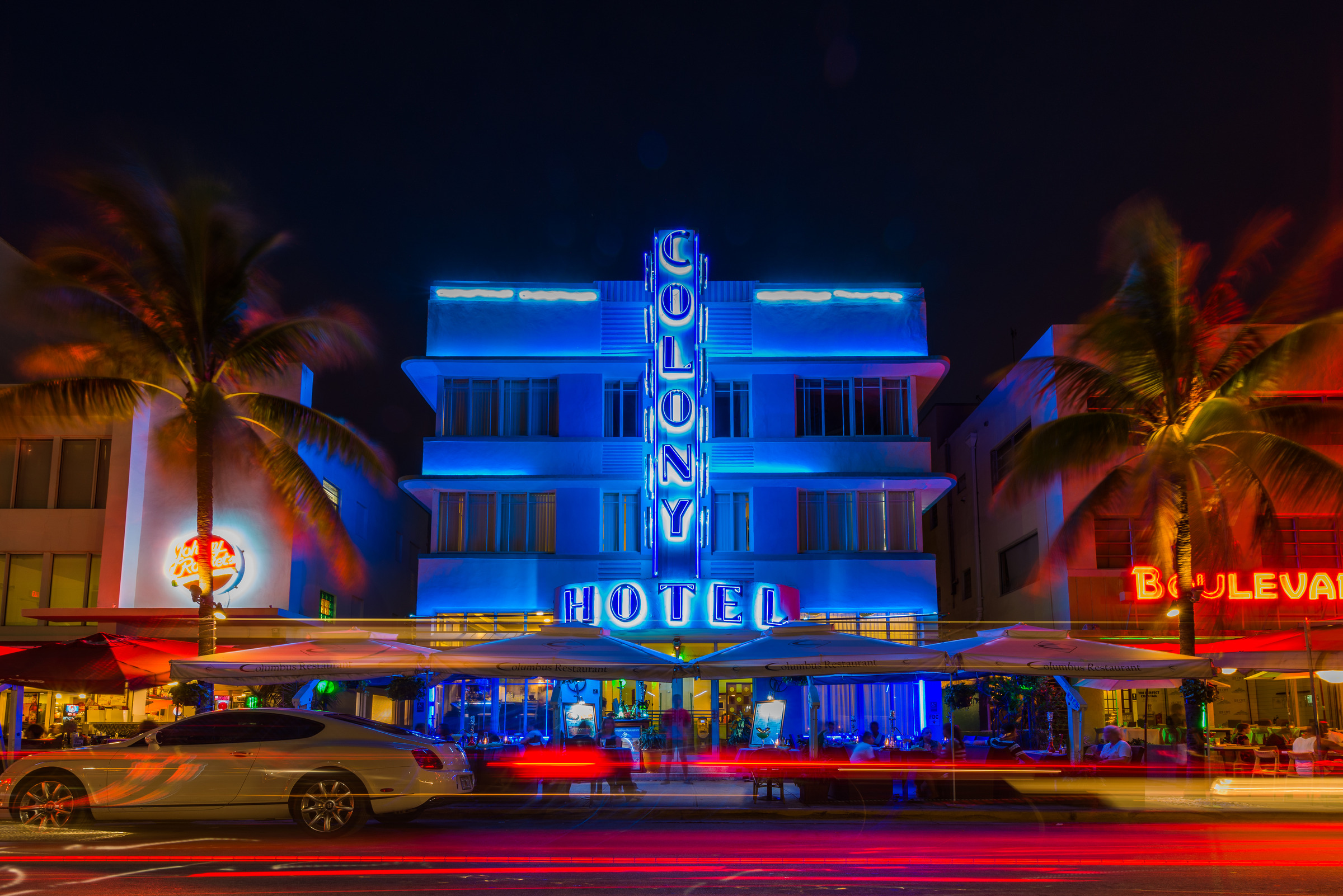 Colony Hotel neon signs lighting up Ocean Drive at night, Miami Beach