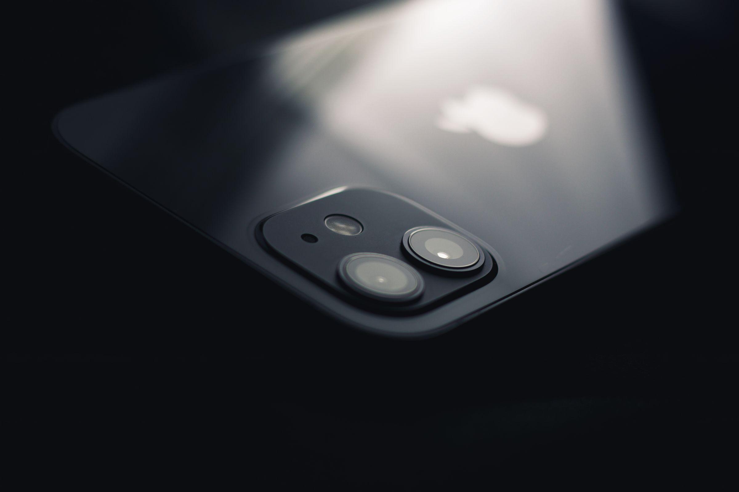 Close-up of a smartphone dual-camera module on a dark reflective surface