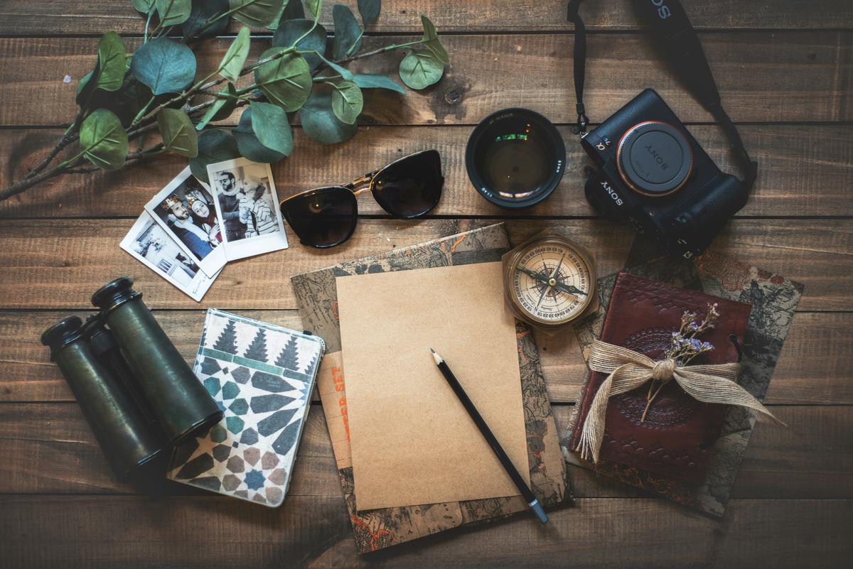 A digital nomad balancing work and travel, showcasing a productive workspace alongside elements of adventure and exploration, like a map or travel gear.