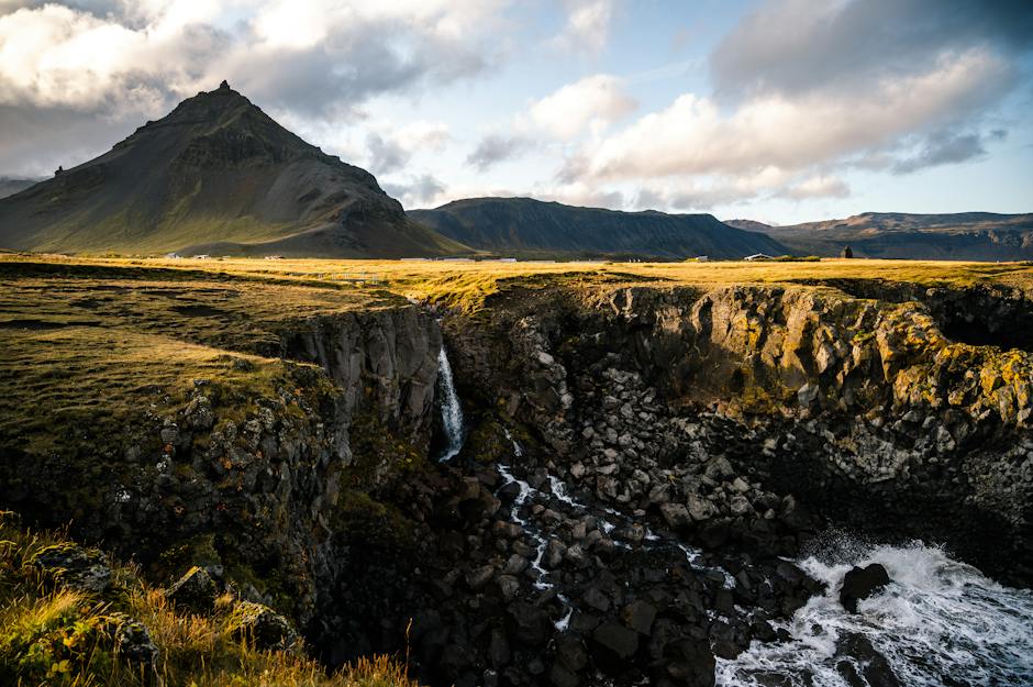 A breathtaking landscape with mountains, wildflowers, and a winding river.