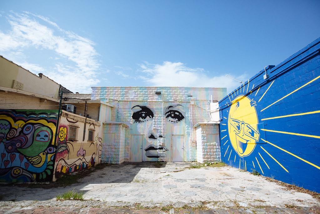 Vibrant street art murals at Wynwood Walls with people admiring the artwork